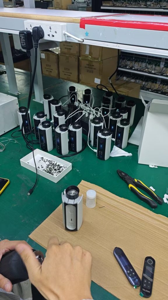 Kwin Electronics worker testing portable fog machines on the assembly line
